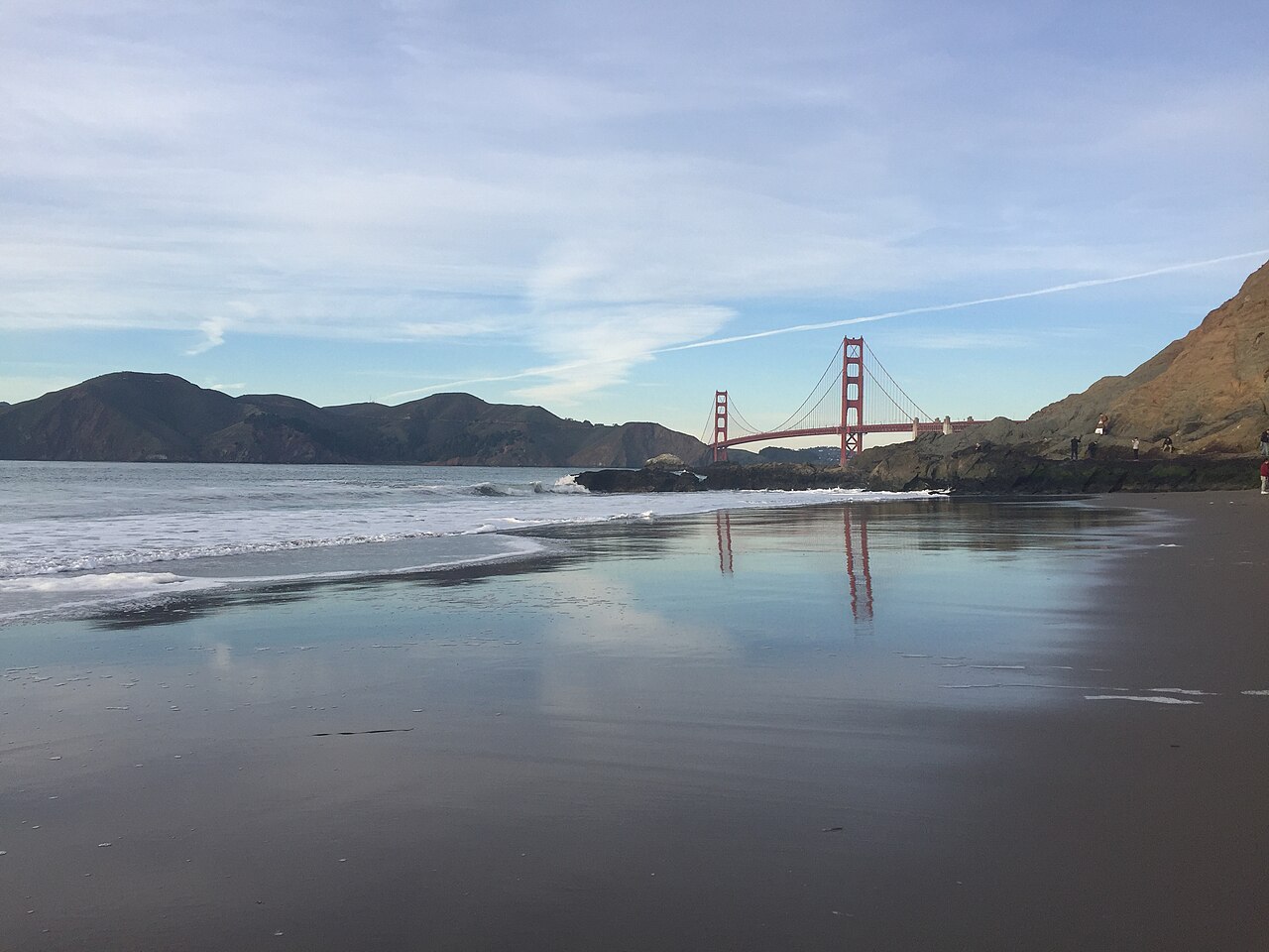 A suspension bridge across a sunlit bay